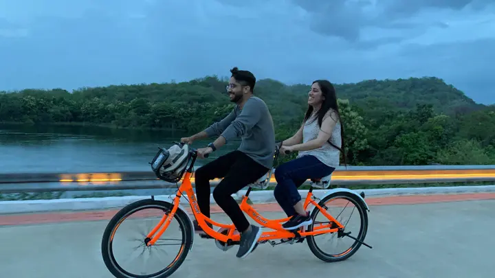Riverfront Couple Cycling